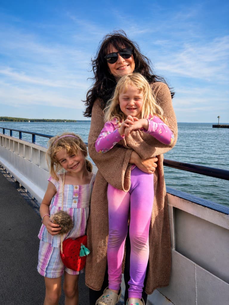 Rose with her two daughters by the water.